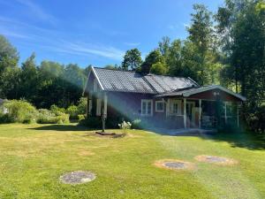 a small house in a yard with smoke coming out at Haus Paula in Sjötorp +2 photos