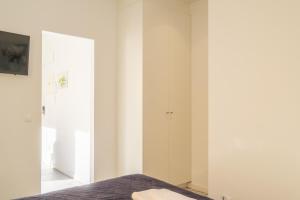 a bedroom with white walls and a bed at Gorgeous Apt with a Large Private Terrace in Valencia
