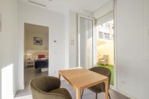 a room with a table and chairs and a bedroom at Gorgeous Apt with a Large Private Terrace in Valencia