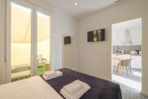 a bedroom with a bed and a view of a kitchen at Gorgeous Apt with a Large Private Terrace in Valencia
