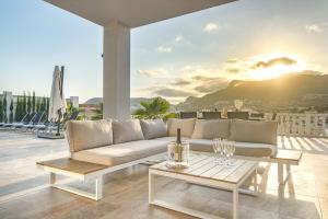 a living room with a couch and a table at Villas Guzman - Grandiosa in Calpe +29 photos