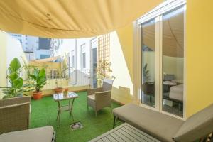 a room with a balcony with a table and chairs at Gorgeous Apt with a Large Private Terrace in Valencia
