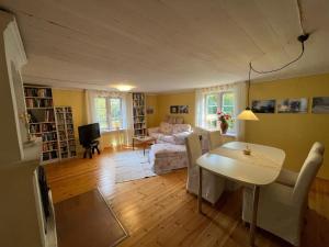 a living room with a table and a couch at Haus Paula in Sjötorp