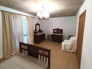 a living room with a couch and a chair at Casa da Volta - Porto Moniz in Porto Moniz