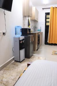 a kitchen with a stove and a refrigerator at Kwetu properties in Nairobi