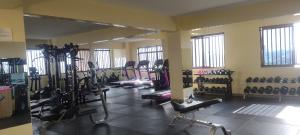 a gym with a bunch of tread machines in a room at Kwetu properties in Nairobi
