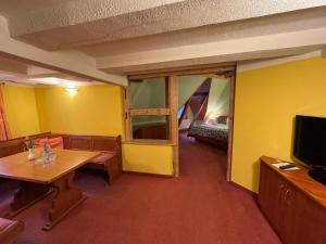 a room with a living room with a tv and a bed at Hotel Zum Kanzler in Stolberg