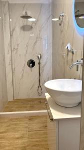 a bathroom with a sink and a shower at Aggelos Room 3 in Volos