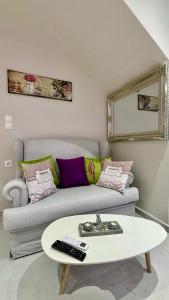 a living room with a couch and a coffee table at Aggelos Room 3 in Volos