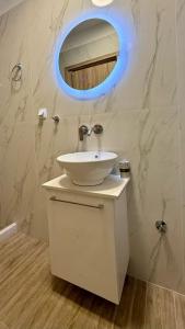 a bathroom with a white sink and a mirror at Aggelos Room 3 in Volos