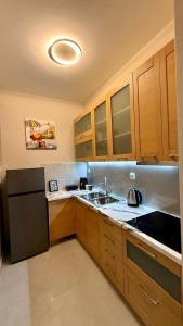 a kitchen with wooden cabinets and a sink at Aggelos Room 3 in Volos