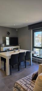 a living room with a table and chairs and a tv at Casa Arena 2 in Nigrán