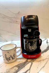 a coffee maker and a cup on a counter at Aggelos Room 3 in Volos