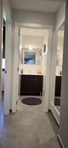a hallway with a sink and a mirror at Casa Arena 2 in Nigrán +21 photos