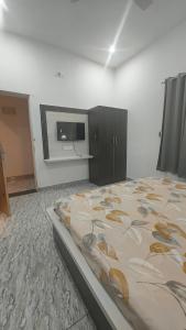 a bedroom with a bed and a flat screen tv at Shree Karan Palace Family Guest House in Juliāsar +2 photos