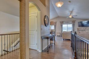 a living room with a staircase and a clock on the wall at Rangeview Pass Pet Friendly with Epic Peak Views in Monument +59 photos