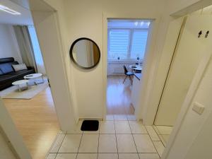 a hallway leading to a living room with a mirror at Dein Apartment mit Queensize Bett im Erdgeschoss in Neukirchen-Vluyn +11 photos