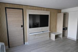 a room with a sliding door with a flat screen tv at Tropical Palms Hotel in Clearwater