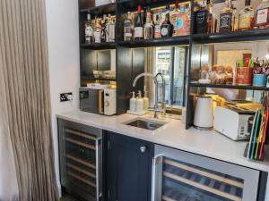a kitchen with a counter top with a sink and a sink at The Summerhouse in Keighley