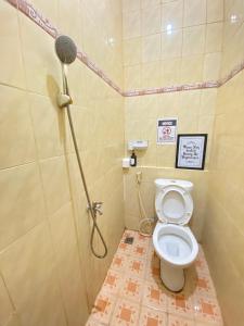 a bathroom with a shower with a toilet in it at Good Feeling Ijen Banyuwangi in Banyuwangi