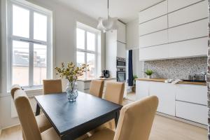 a kitchen and dining room with a table and chairs at Spacious Five Bedroom Central Oslo in Oslo