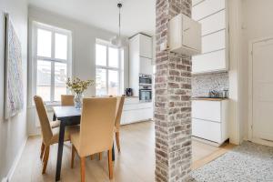 a kitchen and dining room with a table and chairs at Spacious Five Bedroom Central Oslo in Oslo