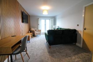 a living room with a couch and a table at Restful Riverside Residence in Morton