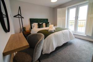 a bedroom with a bed and a chair at Restful Riverside Residence in Morton