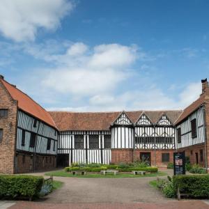 an old building with black and white buildings at Restful Riverside Residence in Morton