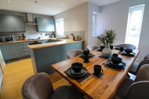 a kitchen with a wooden table with chairs around it at Restful Riverside Residence in Morton