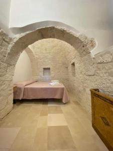 a room with a table in a stone wall at Trullo al borgo in Cisternino +19 photos