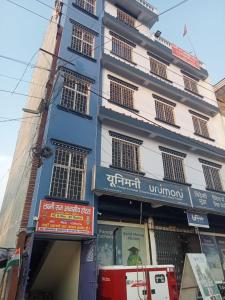 a blue and white building with signs in front of it at Laxmi raj awasiye hotel in Bettiah