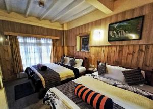 a hotel room with two beds and a window at Sekenani,Leparan Lodge in Narok