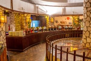 a restaurant with a counter and a bar at Sekenani,Leparan Lodge in Narok