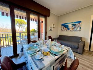 a dining room table with a blue and white table cloth at Premium Apartments Peschiera in Peschiera del Garda