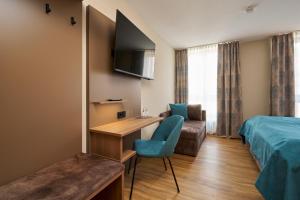 a hotel room with a bed and a desk and a couch at Hotel Am Dom in Bamberg