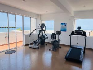 a gym with treadmills and exercise bikes in a room with the beach at Liyasha Villa - AEONSKY in Negombo