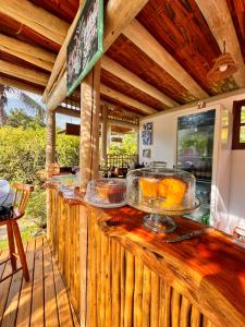 a restaurant counter with trays of food on it at FLORA Praia do Sono in Paraty