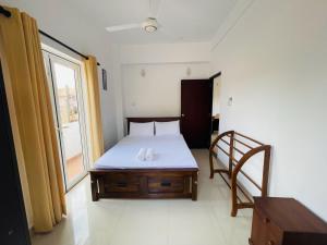 a small bedroom with a bed and a window at Liyasha Villa - AEONSKY in Negombo +44 photos