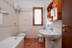 a white bathroom with a sink and a toilet at ilvilLINO in Taranto +13 photos