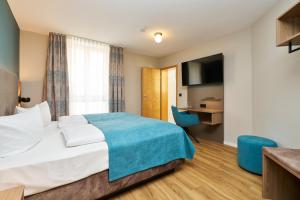 a hotel room with a bed and a desk at Hotel Am Dom in Bamberg