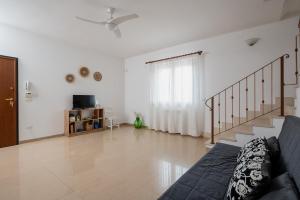 a living room with a couch and a staircase at ilvilLINO in Taranto