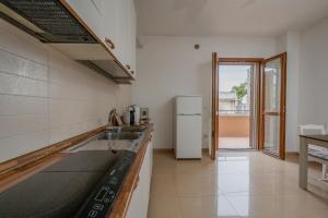 a kitchen with a sink and a refrigerator at ilvilLINO in Taranto