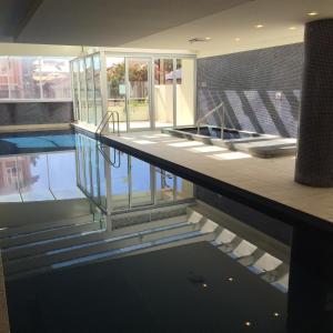 a swimming pool in a building with a swimming pool at GlenelgApt in Adelaide