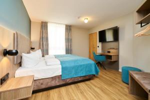 a hotel room with a bed and a television at Hotel Am Dom in Bamberg +13 photos