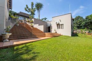 a house with stairs and a grass yard at The Old Stone House in Kloof