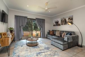 a living room with a couch and a table at The Old Stone House in Kloof