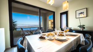 a table with food on it with a view of the ocean at Villa Majestic Heated Pool Sauna & Endless Sea Views in Megála Khoráfia
