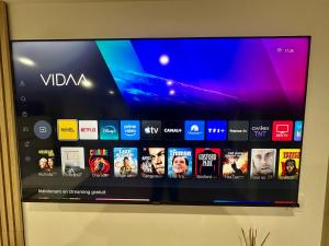 a flat screen tv on a wall with many apps at Relax & Cosy Saint Just Saint Rambert in Saint-Rambert-sur-Loire