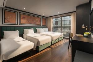a hotel room with two beds and a desk and a window at Embrace Boutique Hanoi Hotel in Hanoi +43 photos